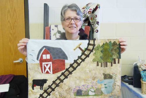 Plevna quilter, Debbie Emery with a sample section of her winning 150th anniversary quilt design that will be unveiled at the County's official 150th anniversary celebrations, which will take place in Harrowsmith from August 28-30.  